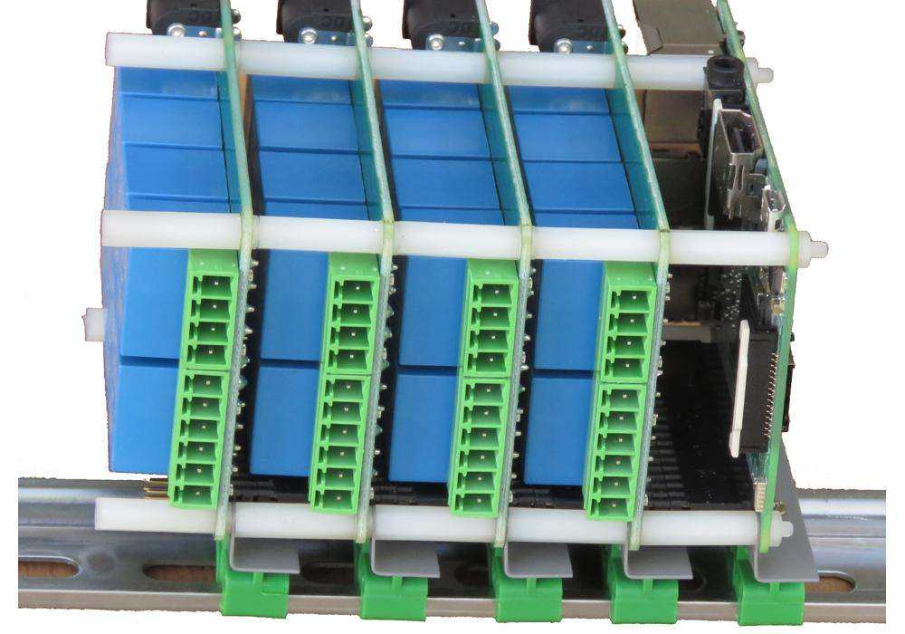 DIN-RAIL Kit with blue circuit boards mounted perpendicular to a metal rail, featuring green terminal blocks and brackets
