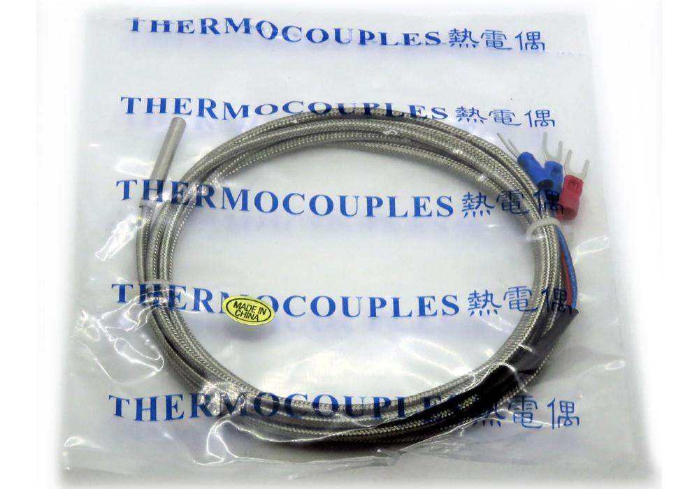 PT100 Sensor with a coiled braided metallic lead and red and blue three-prong terminals, packaged in clear plastic