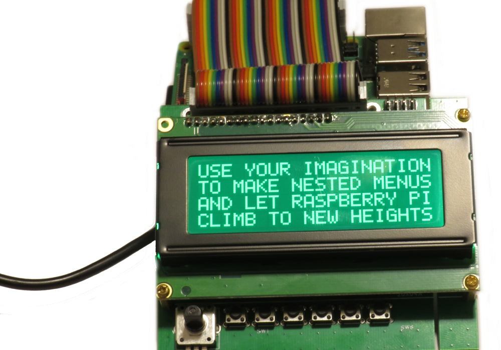 Six-in-one LCD Adapter with a green monochrome text display, multicolour ribbon cable, rotary encoder and six buttons