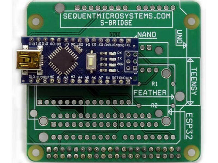 Arduino Uno replacement adapter board with green circuit board, white processor socket labels, and a blue microcontroller