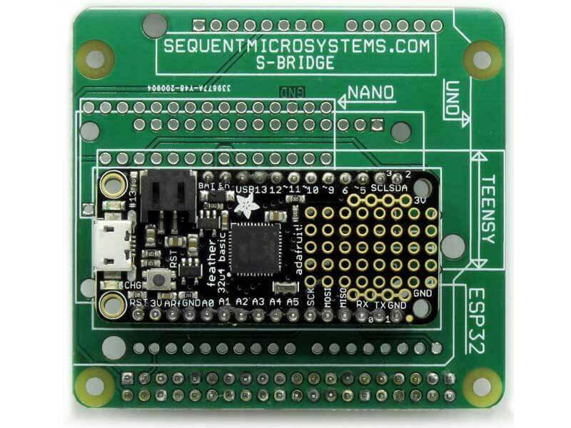 Arduino Uno replacement adapter PCB in green, with black microcontroller board, gold contacts and multiple processor socket outlines