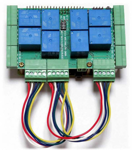 Home Automation circuit board with blue relays, green screw terminals and multicoloured loopback test wires